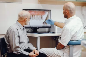Consultation with an older patient about dental mini implants